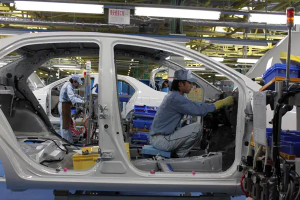 Workers assembling a vehicle at Toyota’s Ohira plant near Sendai, Japan, February 2011.